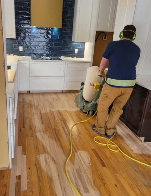 contractor polishing floors on a kitchen remodeling loveland co